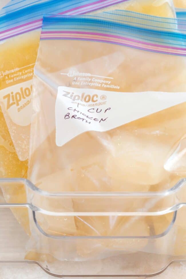 Ziploc freezer bags filled with frozen chicken broth ice cubes.