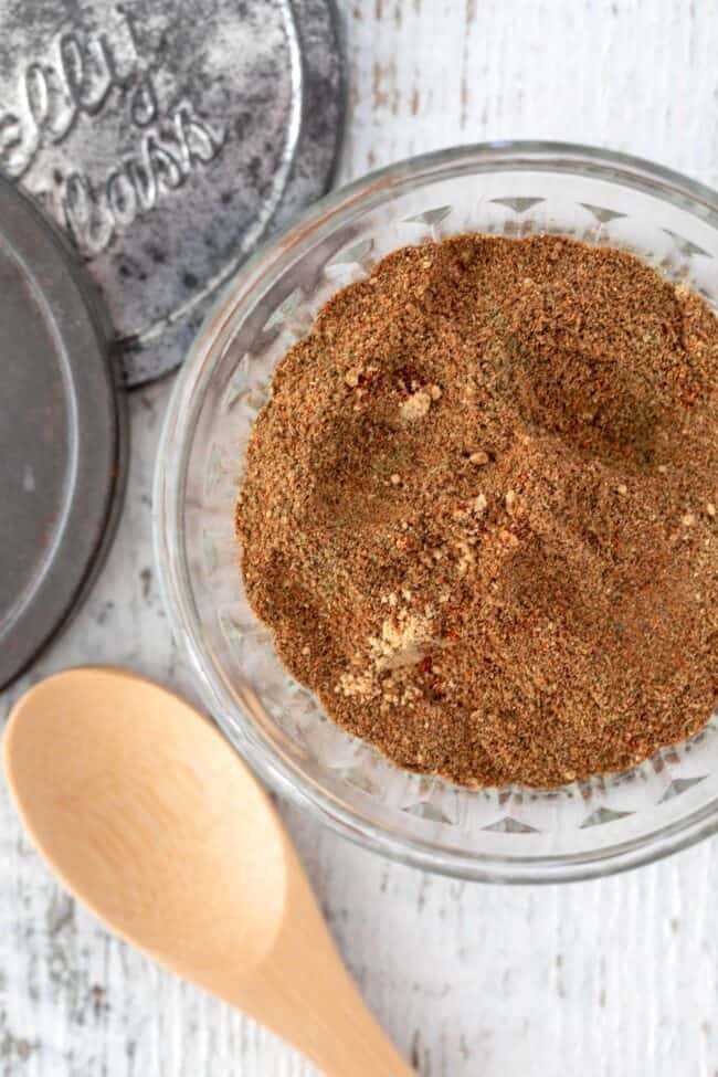 A clear glass jar of homemade shawarma seasoning spice blend.