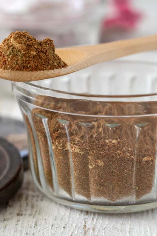 A clear glass jar of shawarma seasoning.