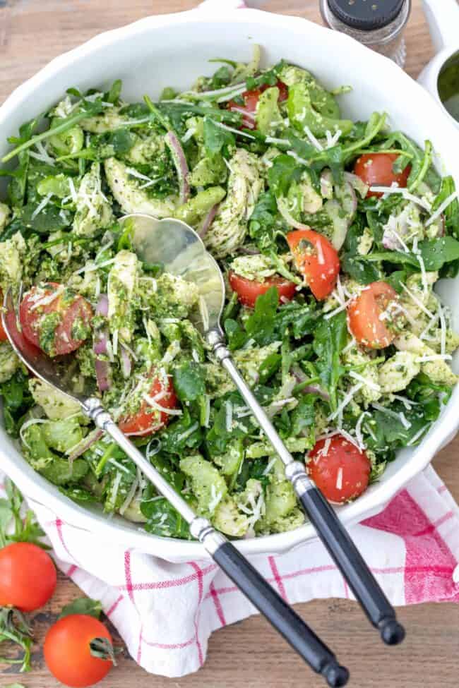 A white bowl of basil pesto chicken salad