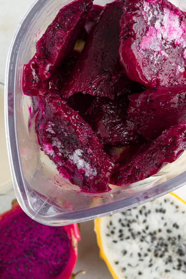 A blender with frozen fruit.