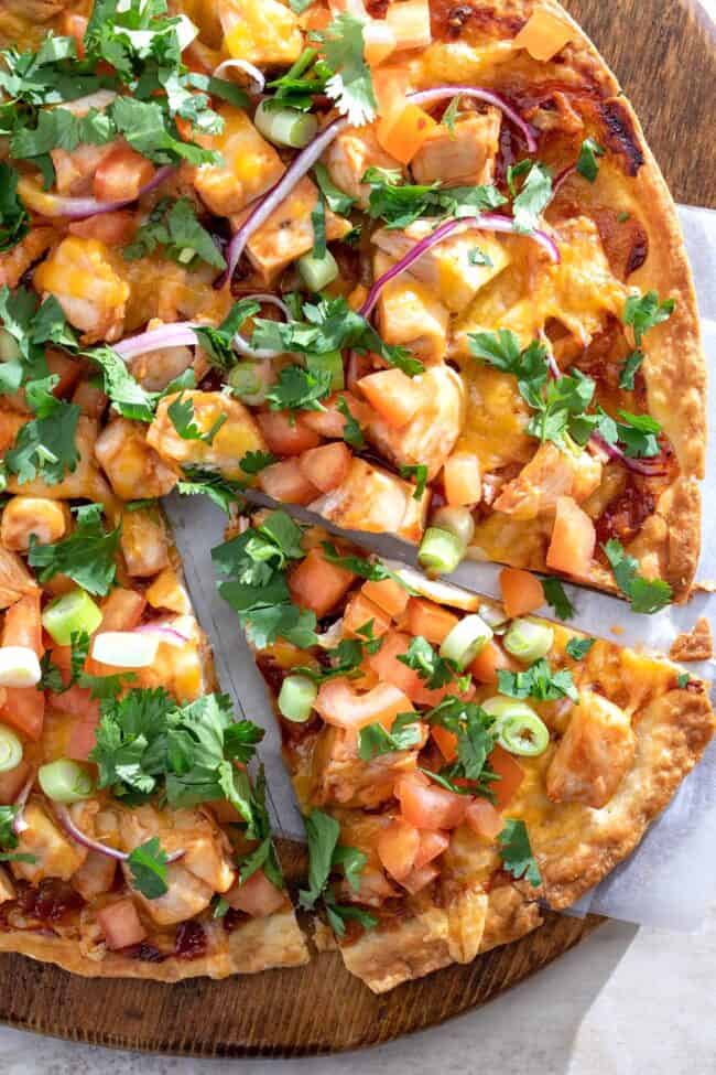 A bbq chicken tortilla pizza sliced.