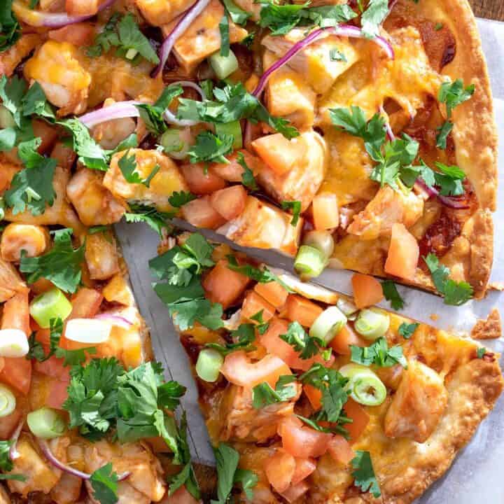 A bbq chicken tortilla pizza sliced.
