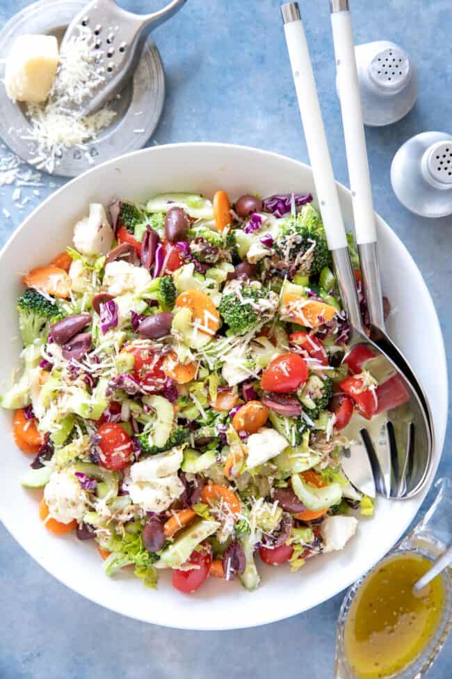 A white bowl of chopped broccoli & cauliflower salad.