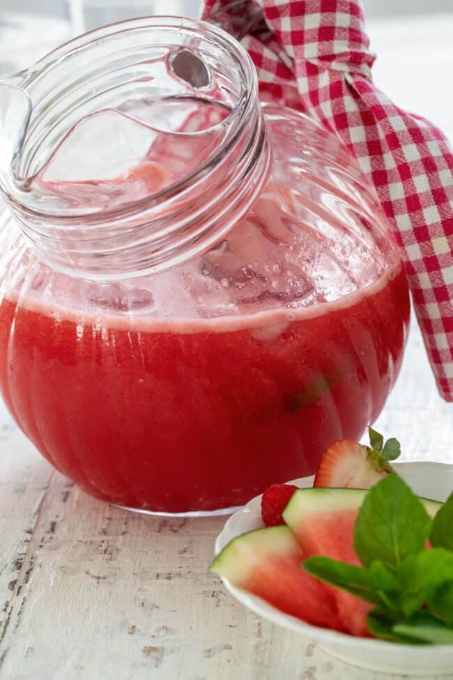 clear glass pitcher of watermelon juice