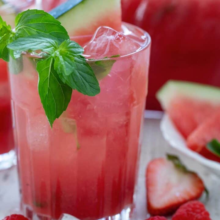 A clear drinking glass of watermelon juice.