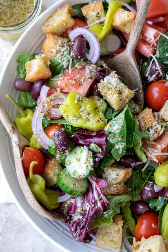 A white bowl with Italian green salad.