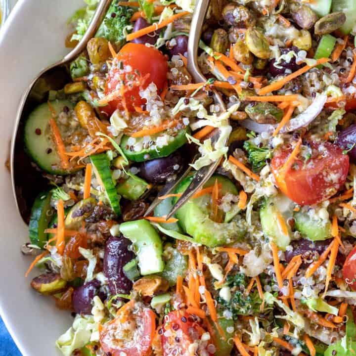 A white bowl filled with the Best Quinoa Salad (tri color quinoa salad).