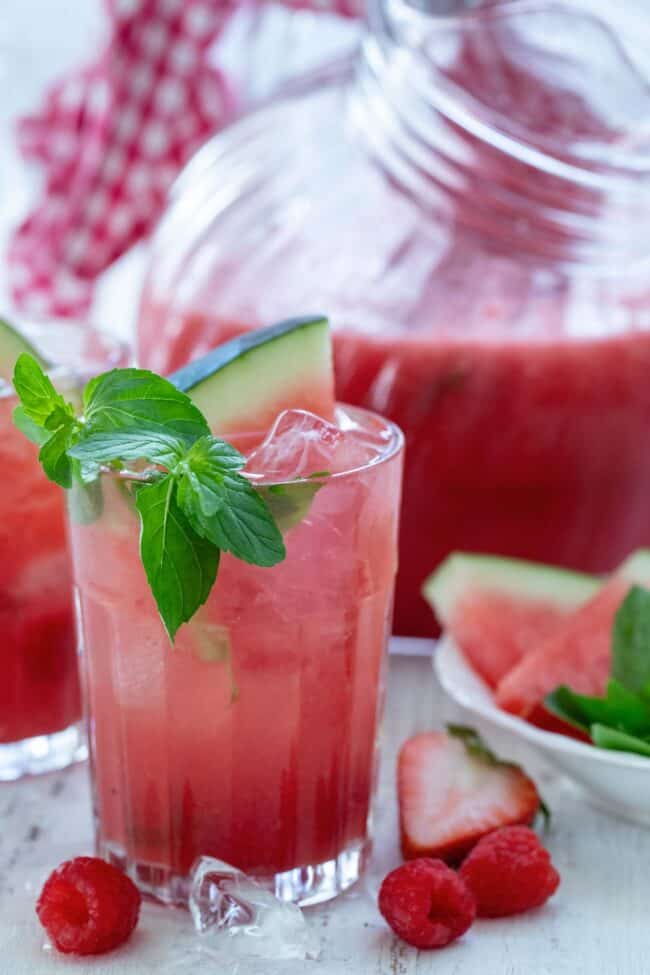 A clear drinking glass of fruit necter. 