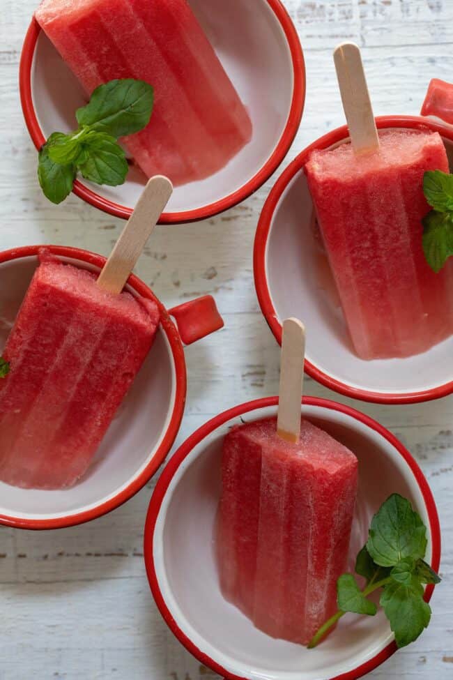 frozen fruit paletas in white cups