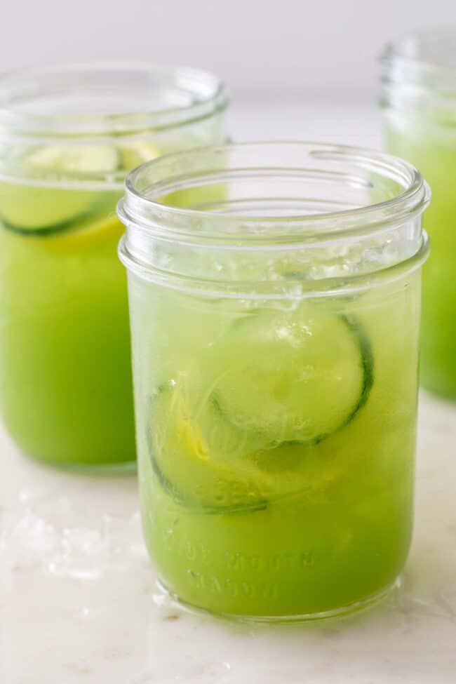 three clear mason jars filled with cucumber juice