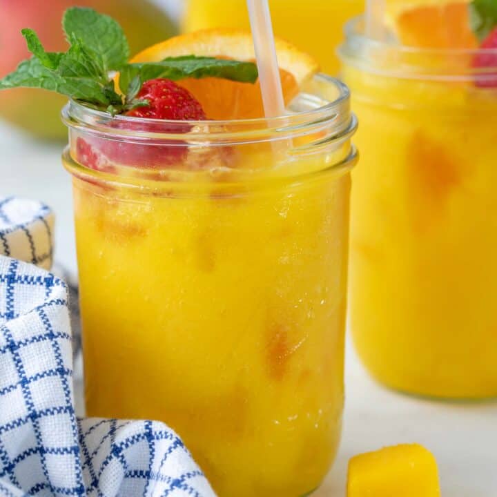 Two glasses filled with mango juice.