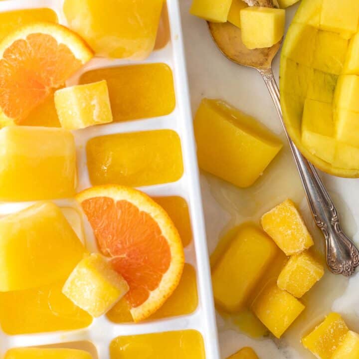 white ice cube tray filled with mango nectar ice cubes