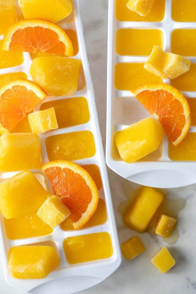 Two white ice cube trays filled with mango (king of fruits) nectar ice cubes. 