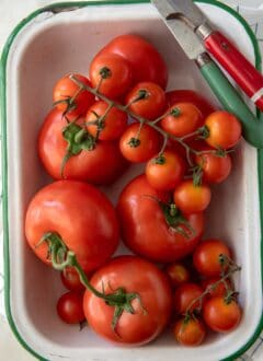 Here are a few easy tips to know about How to Store Tomatoes so they last longer. We'll also answer a few common questions, like should you refrigerate tomatoes? How long do tomatoes last? How long do tomatoes last in the fridge? And can you freeze tomatoes?