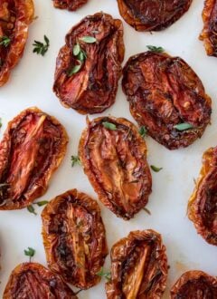 sun dried tomatoes on a white marble board.