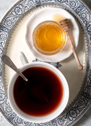 White tea cup filled with elderberry tea.