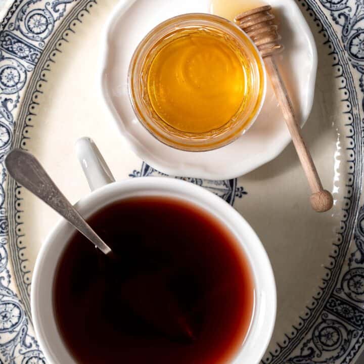 White tea cup filled with elderberry tea.