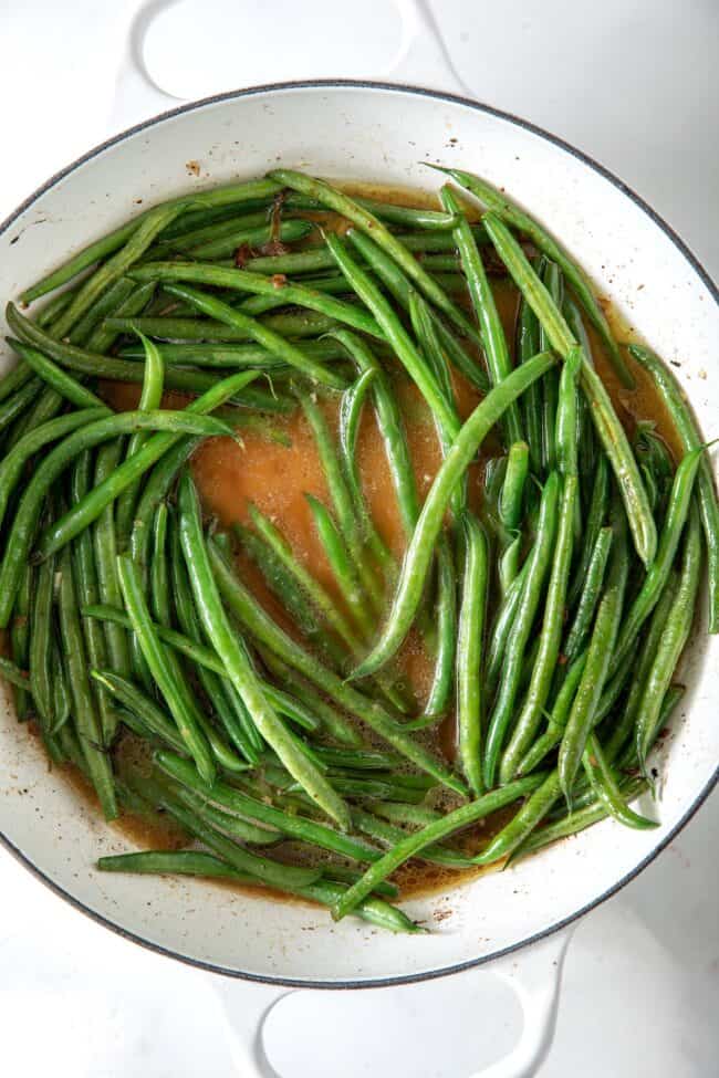 White skillet filled with haricot vert (French green beans) 