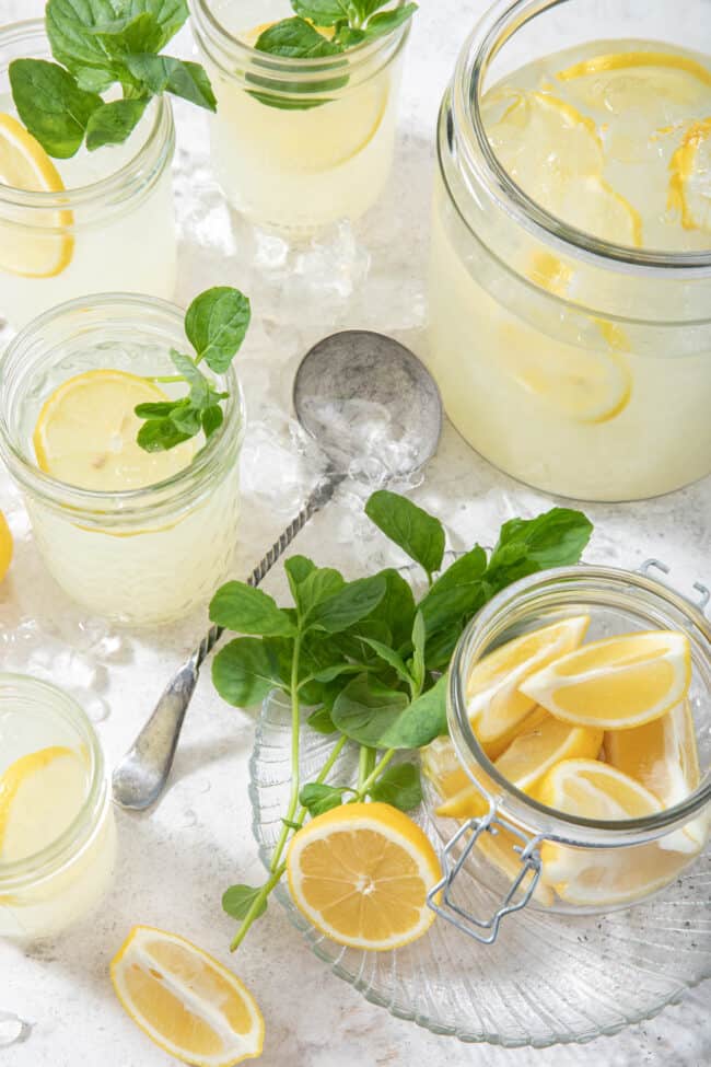 glass jars filled with lemonade and sprigs of mint