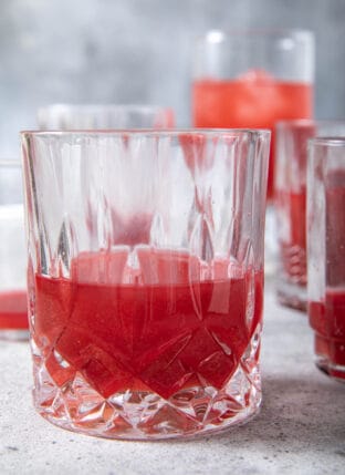 Several glasses filled with fresh beet juice.