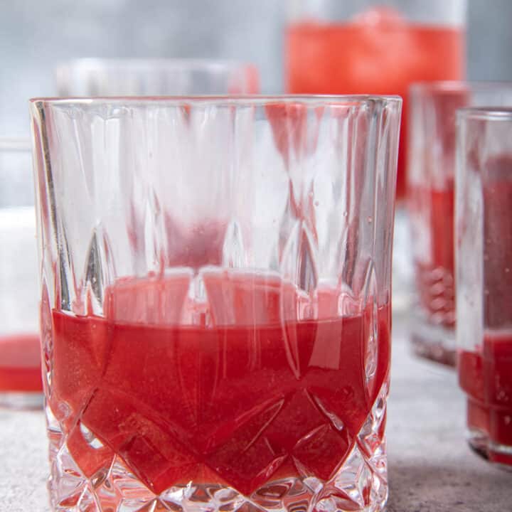 Several glasses filled with fresh beet juice.