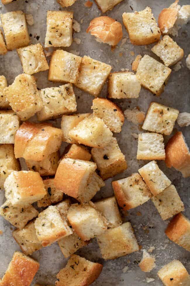 Cookie sheet filled with homemade croutons for how to make croutons