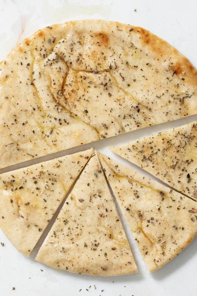 A pita bread cut in half and one have is cut in 4 triangles.