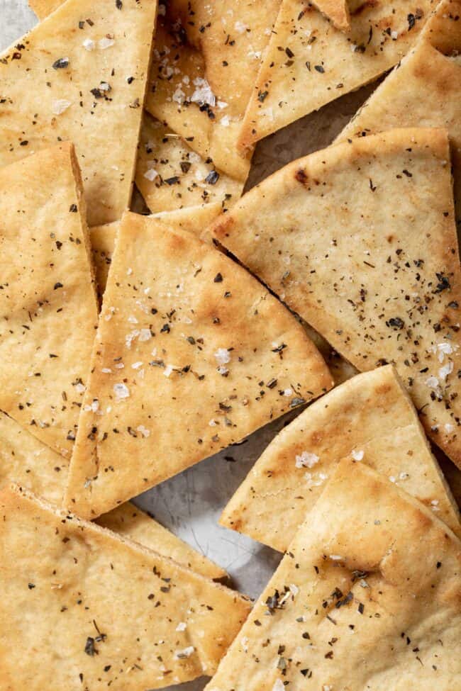 Baked pita chips on a baking sheet.