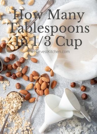 cashews, filberts, almonds, oats and shredded coconut scattered next to a bowl filled with cheese cloth and almond milk for how many tablespoons in 1/3 cup