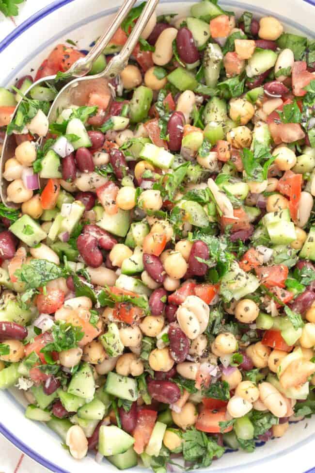 blue and white bowl filled with three bean salad