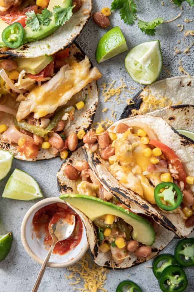 corn tortillas stuffed with chicken, pinto beans, fajita veggies, cheese and avocado.