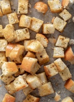 A cookie sheet filled with homemade croutons