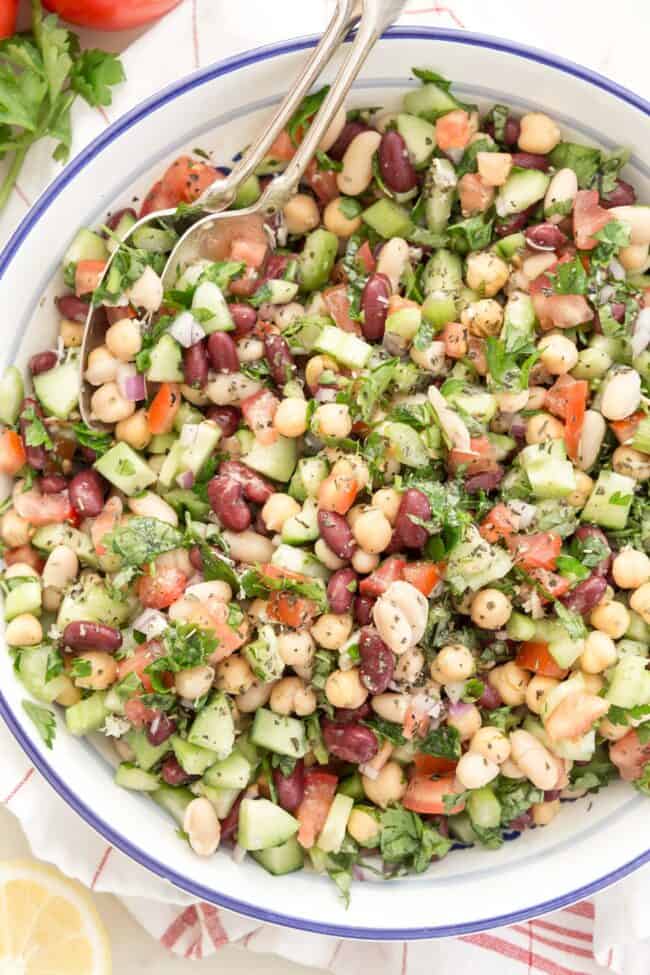 white and blue bowl filled with three bean salad 
