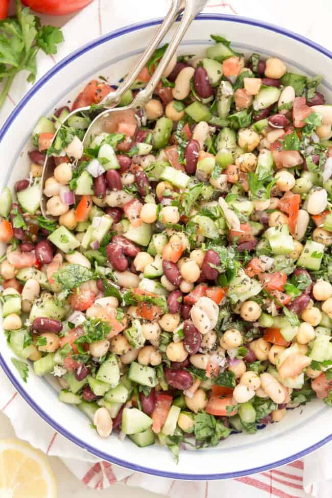 white and blue bowl filled with three bean salad 