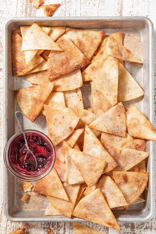 A cookie sheet filled with fried flour tortillas.