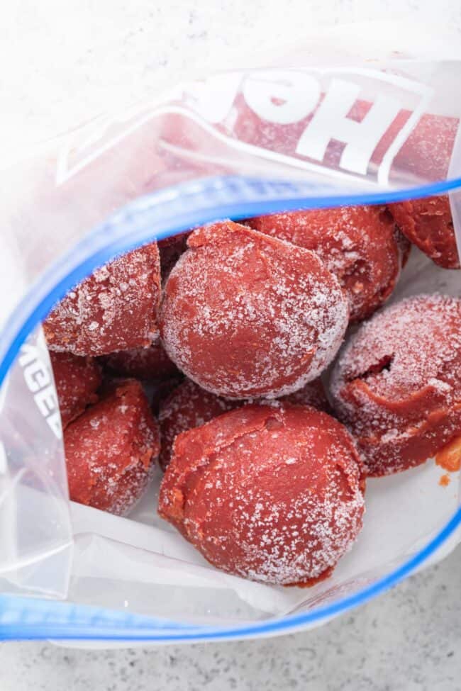A freezer bag filled with frozen balls of tomato paste (for How to Freeze Tomato Paste).