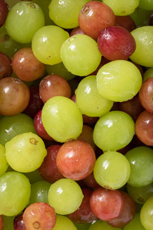 Red and green grapes in a colander