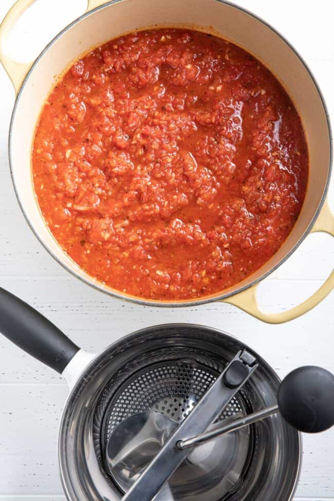 A yellow pot filled with a red sauce.