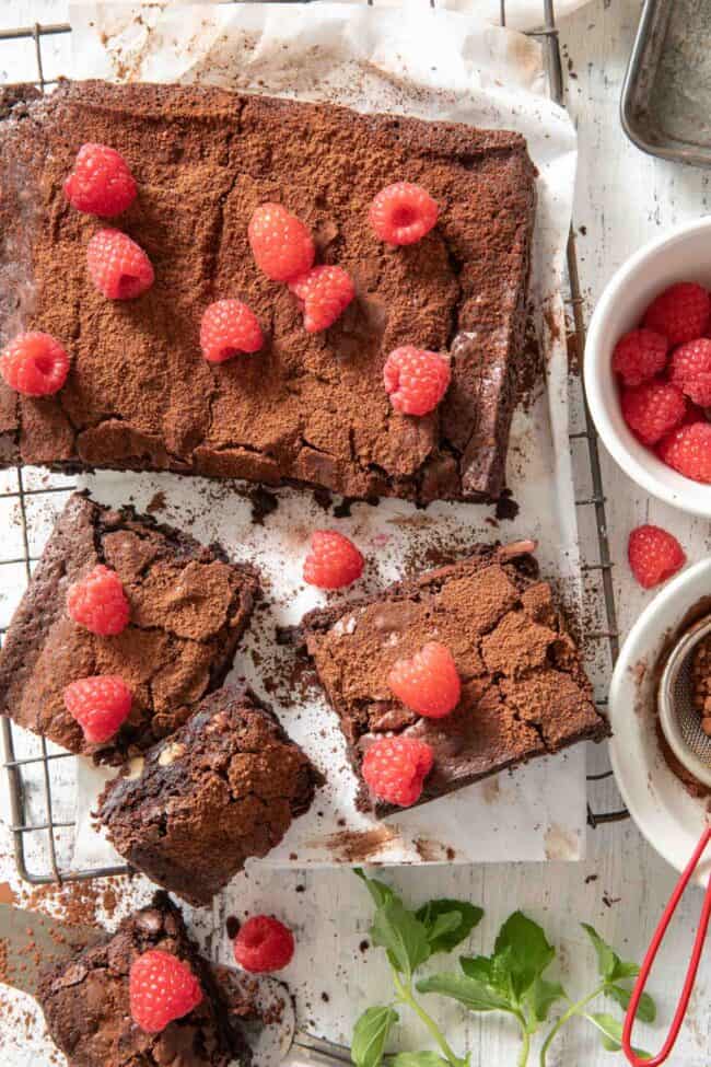 Cut brownies sit on a cooling rack with a bowl or raspberries sitting next to them. For how many grams in a pound.