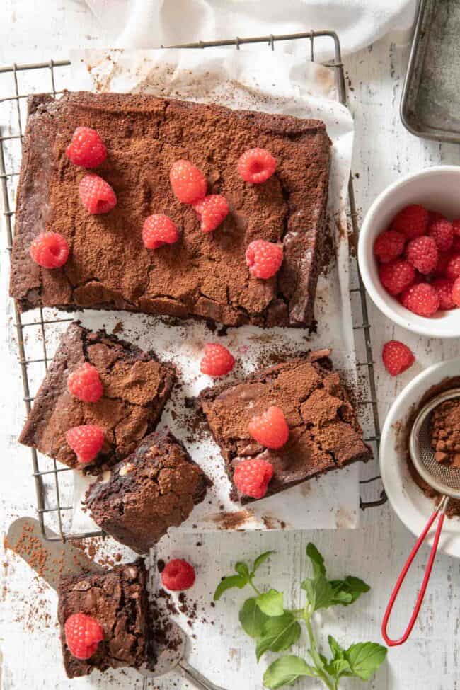 Cut brownies sit on a cooling rack with a bowl or raspberries sitting next to them. For how many grams in a pound.