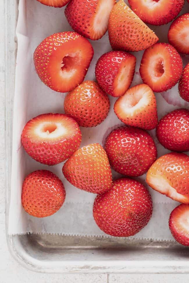 Fresh sliced fruit on a baking sheet.