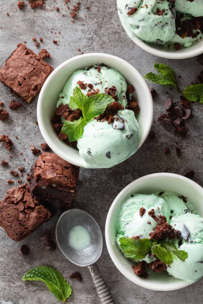 Three small white bowls filled with mint chocolate chip ice cream with brownies crumbled on top - for how many pints in a gallon.