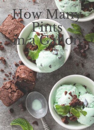 Three small white bowls filled with mint chocolate chip ice cream with brownies crumbled on top.