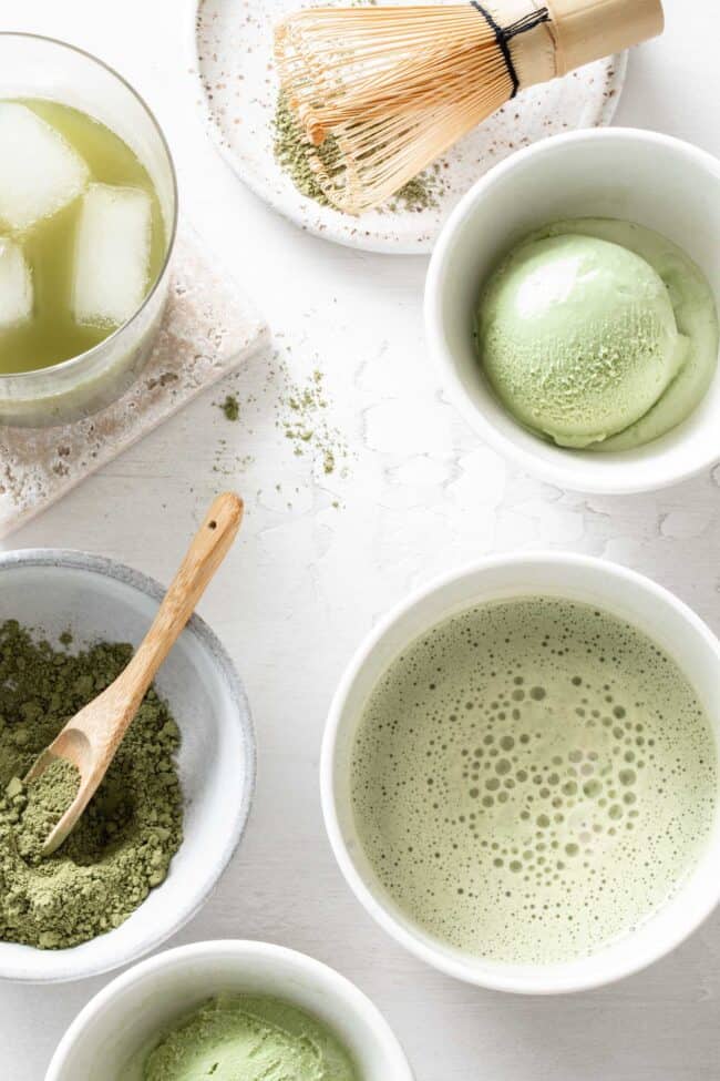 White cups filled with matcha latte, matcha ice cream and dried matcha powder with a wooden spoon (for how many tablespoons in an ounce (tbsp to oz)).