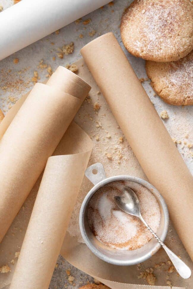 Three rolls of parchment paper scattered on a surface for parchment paper substitute
