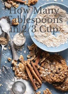 A small blue bowl filled with raw oatmeal next to cinnamon sticks, pears and walnuts for how many tablespoons in 2/3 cup.