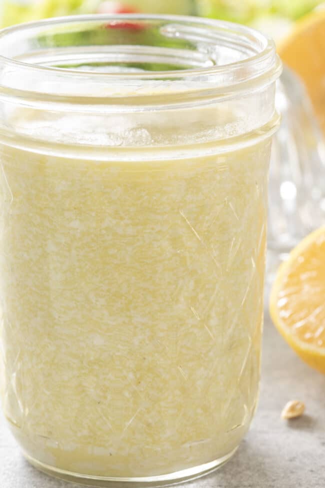 A clear glass mason jar filled with creamy Gorgonzola dressing.