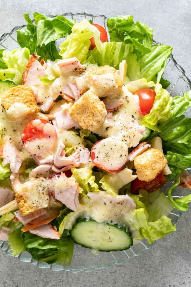 A clear glass plate filled with salad.