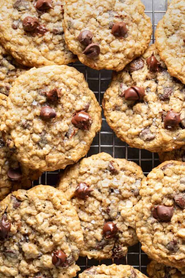 Several oatmeal chocolate chip cookes on a cooling rack.